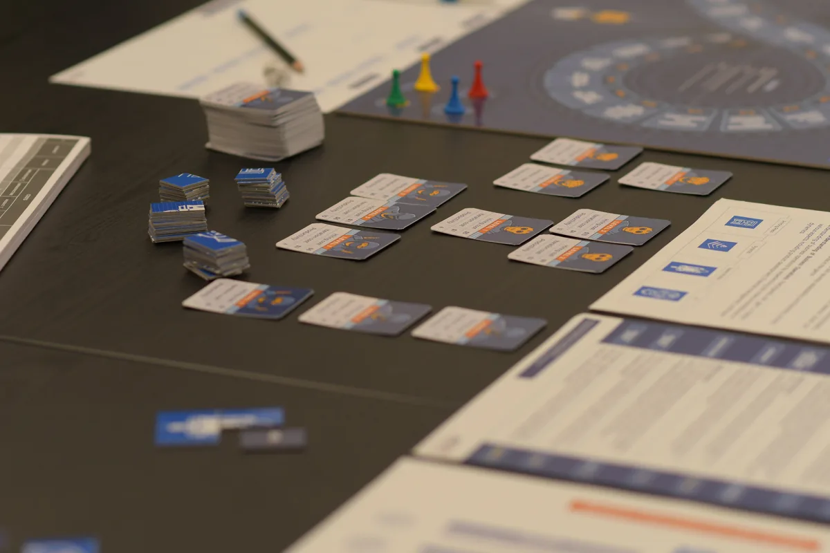 Agilist board, product cards and business simulation materials laid out on a table